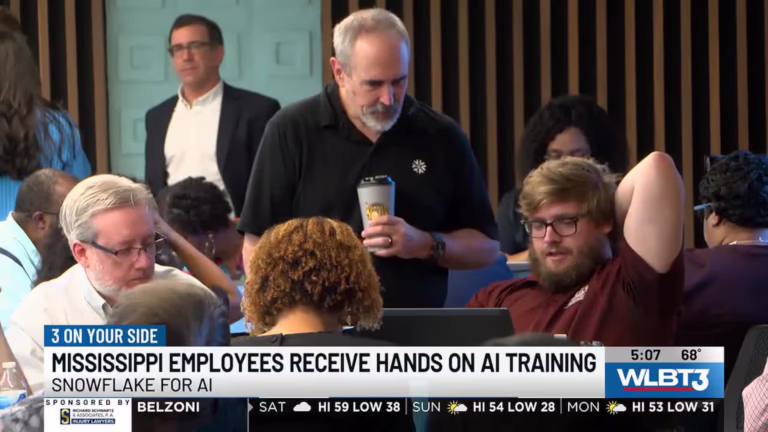 Mississippi state employees participate in hands-on Snowflake AI training during a WLBT news report.