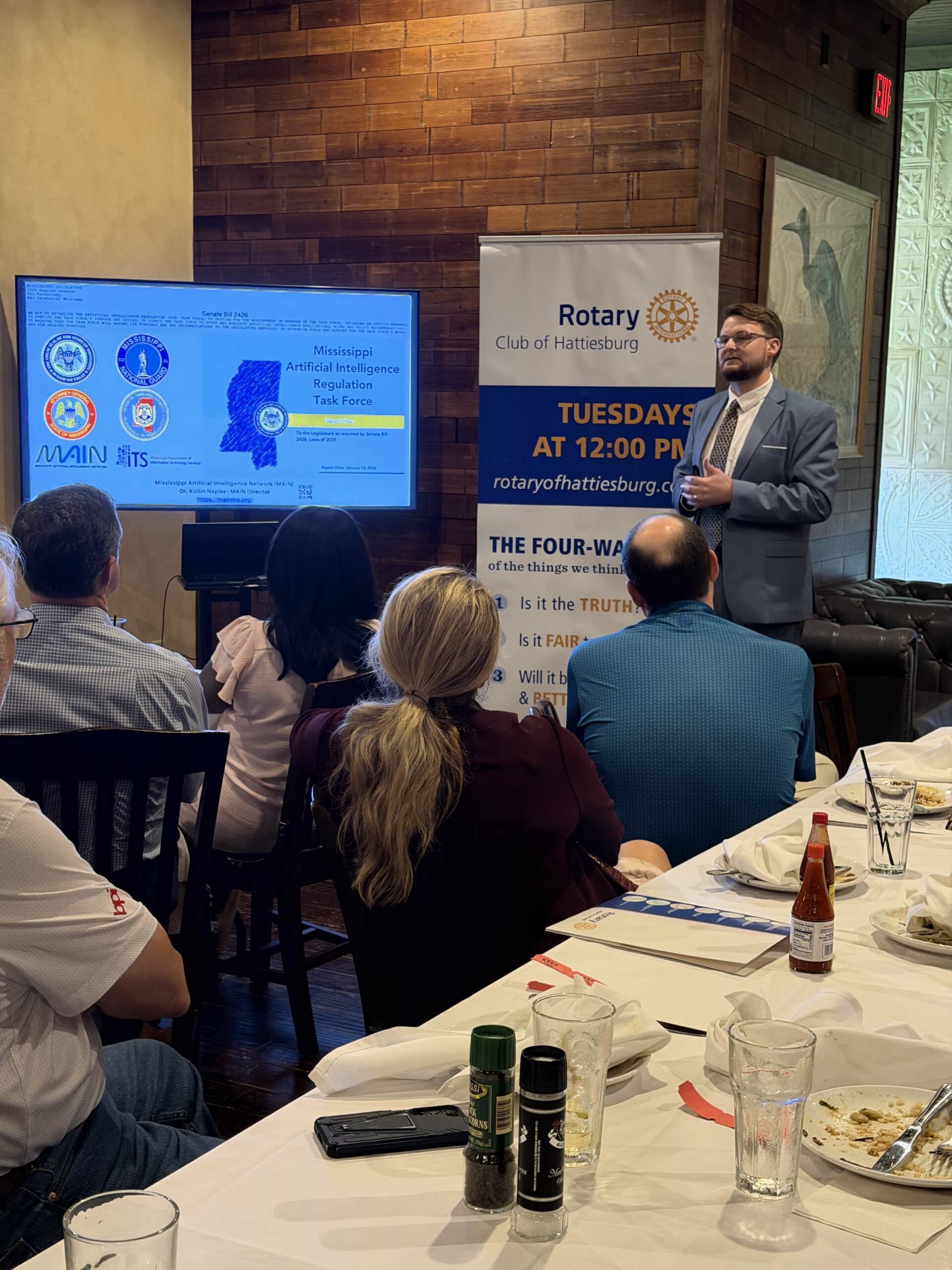 Dr. Kollin Napier speaking with the Rotary Club of Hattiesburg about AI workforce development