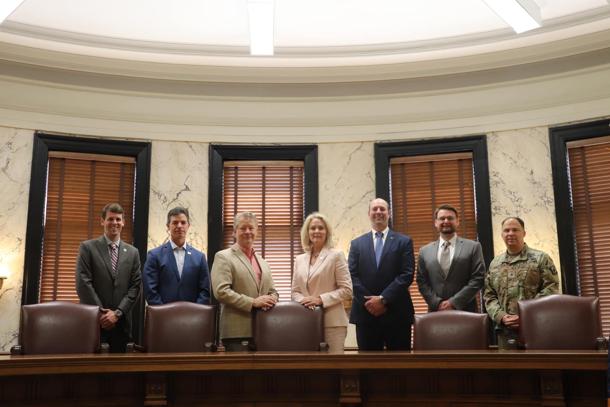 Members of the Mississippi Artificial Intelligence Regulation Task Force standing in a legislative hearing room