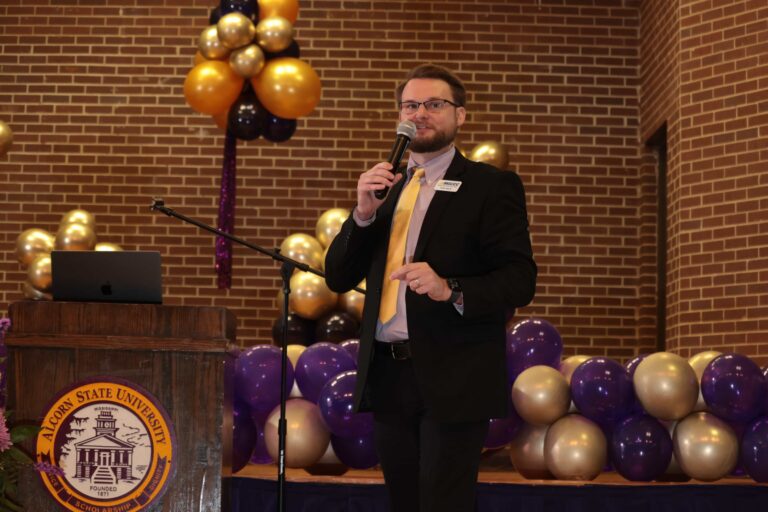 Dr. Kollin Napier speaks at a microphone during Alcorn State University’s 2024 Fall Faculty and Staff Institute.