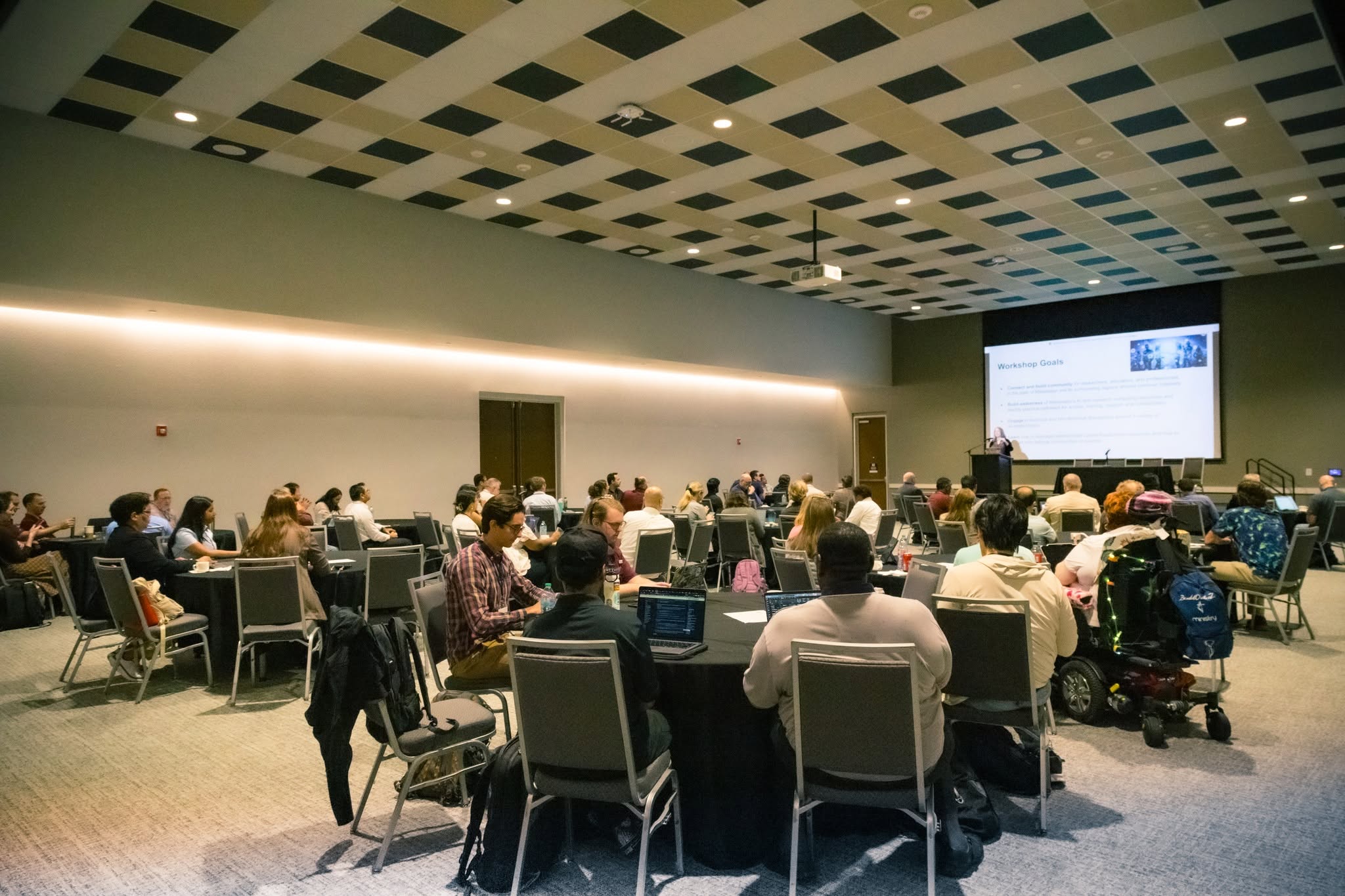 Attendees seated at tables during the AI for All workshop at The Mill at Mississippi State University.