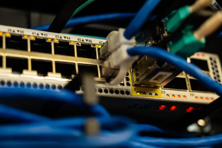 Network equipment with connected Ethernet cables and status indicators.