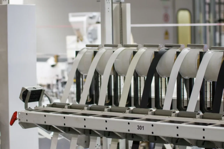 Industrial rollers and material-feed equipment in a manufacturing setting.