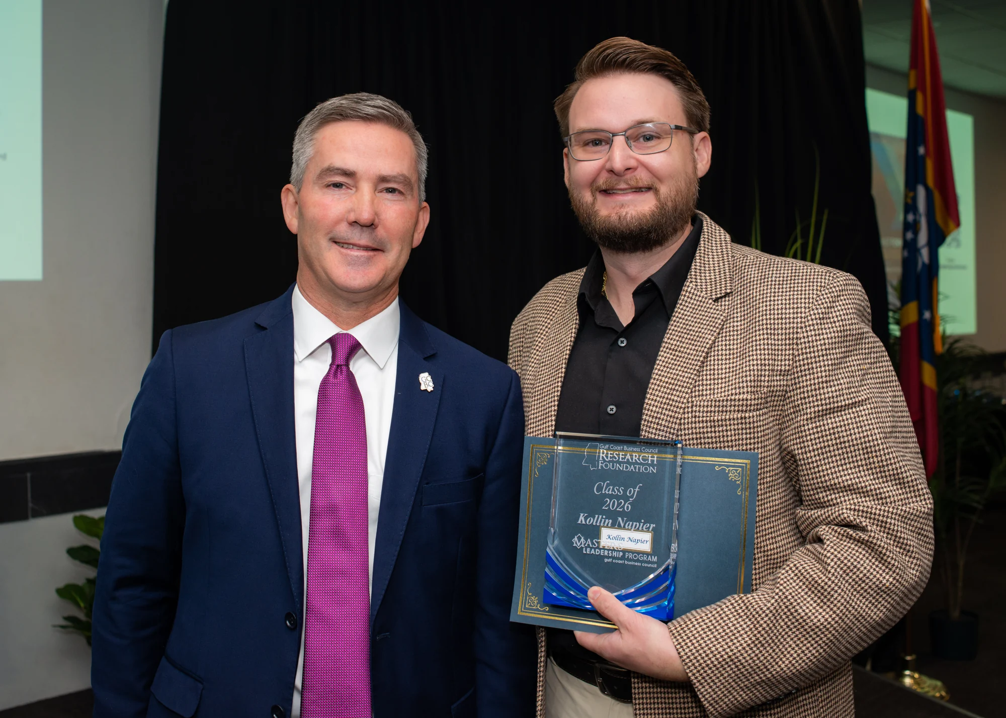 Dr. Kollin Napier, right, holds a Class of 2026 plaque bearing his name.