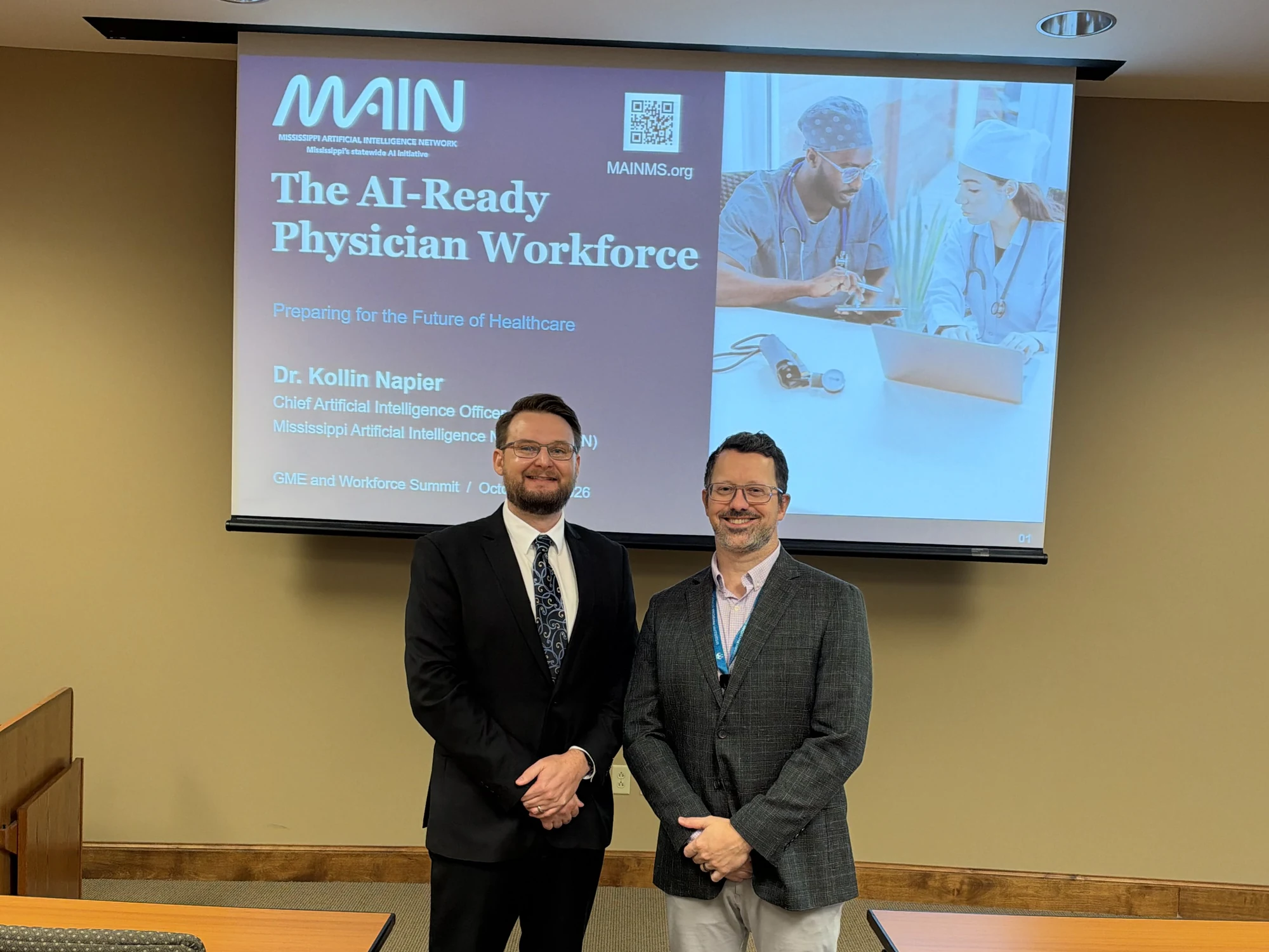 Dr. Kollin Napier, left, and Dr. Richard Calderone stand in front of The AI-Ready Physician Workforce presentation at the GME and Workforce Summit.